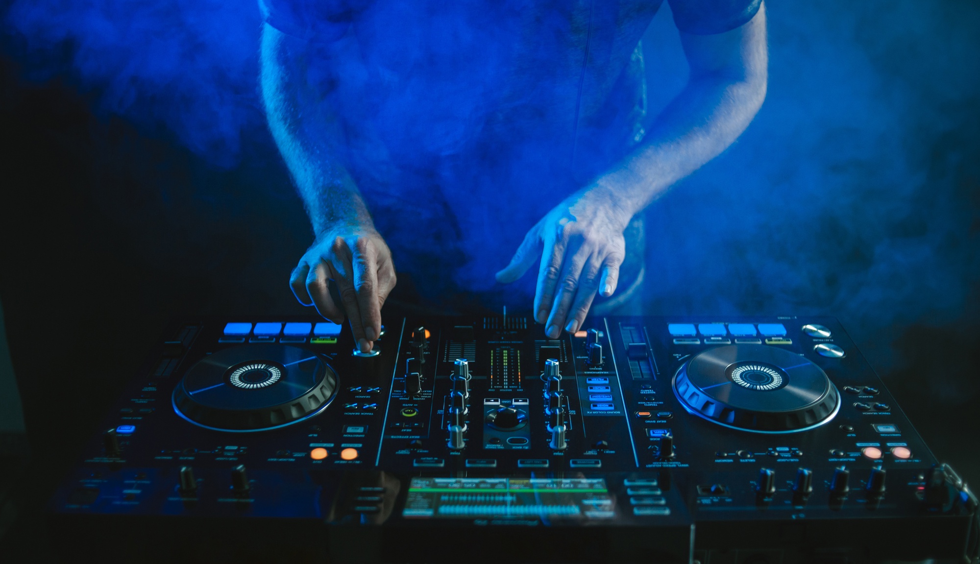 closeup-dj-working-blue-light